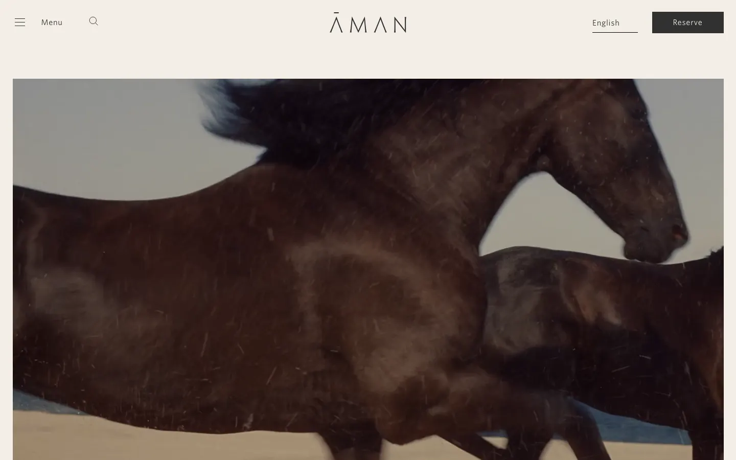 Aman's homepage on 10 October 2026: the Aman wordmark and a Reserve button above a full-width video still of a dark horse running