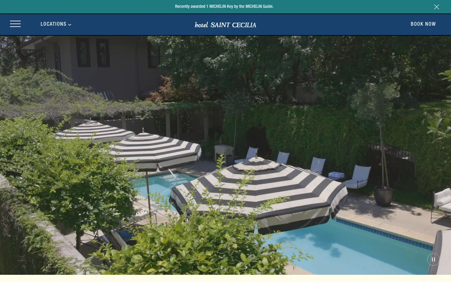 Hotel Saint Cecilia's page on 10 October 2026: a banner reading Recently awarded 1 MICHELIN Key above the hotel's name and a Book Now link, over a photograph of striped umbrellas around a small pool