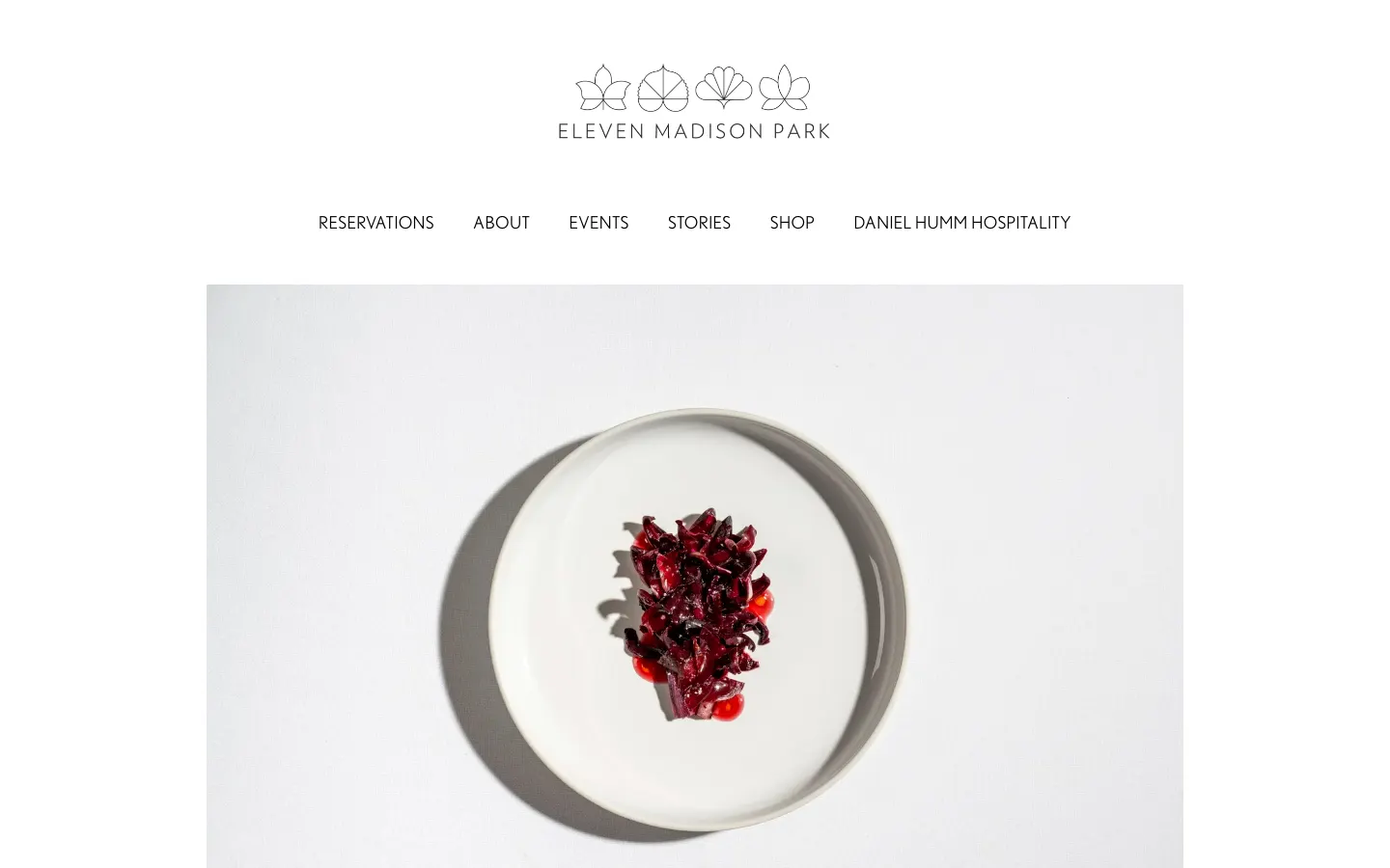Eleven Madison Park's homepage on 30 September 2026: a single dish on a white plate under the restaurant's logo and a row of links