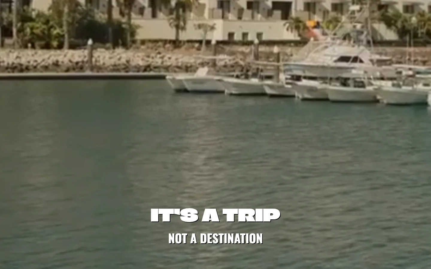 The live Hotel El Ganzo homepage on 20 September 2026: a full-bleed video of the hotel across the marina, with It's A Trip, Not A Destination set across the bottom